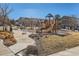 Community playground featuring a slide and swings, surrounded by landscaping at 13624 Garfield St # G, Thornton, CO 80602