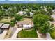 An aerial view showcases a residential home with mature trees, landscaping, and a well-maintained lawn at 8051 S Kendall Blvd, Littleton, CO 80128