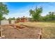 View of a backyard featuring garden beds, a small storage shed, and a brick home exterior at 8051 S Kendall Blvd, Littleton, CO 80128