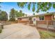 Spacious backyard patio and deck featuring brick accents and ample outdoor entertaining space at 8051 S Kendall Blvd, Littleton, CO 80128