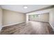 Spacious finished basement area with wood-look flooring and two windows for ample natural light at 8051 S Kendall Blvd, Littleton, CO 80128