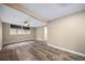 Bright finished basement with wood-look flooring, neutral paint and natural light from two windows at 8051 S Kendall Blvd, Littleton, CO 80128