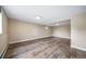 Finished basement featuring wood-look flooring and neutral paint at 8051 S Kendall Blvd, Littleton, CO 80128