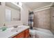 Bathroom with a wood vanity, tile flooring, and a shower and tub combination at 8051 S Kendall Blvd, Littleton, CO 80128
