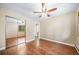 Bedroom with hardwood floors, ceiling fan, neutral paint and mirrored closet doors at 8051 S Kendall Blvd, Littleton, CO 80128