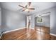 Bedroom with hardwood floors, ceiling fan, neutral paint and mirrored closet doors at 8051 S Kendall Blvd, Littleton, CO 80128