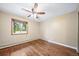 Bedroom with hardwood floors, neutral paint, window, and ceiling fan at 8051 S Kendall Blvd, Littleton, CO 80128