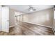 Bright finished bedroom with wood-look flooring, sliding closet doors, and neutral paint at 8051 S Kendall Blvd, Littleton, CO 80128