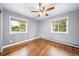 This bedroom has hardwood floors, neutral paint, and two windows that provide lots of natural light at 8051 S Kendall Blvd, Littleton, CO 80128