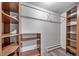Walk-in closet with built in shelves and wood-look flooring at 8051 S Kendall Blvd, Littleton, CO 80128