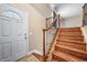Bright entryway with decorative front door and hardwood stairs featuring dark metal spindles at 8051 S Kendall Blvd, Littleton, CO 80128