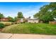Charming single Gathering home featuring a well-manicured lawn and mature trees enhancing its curb appeal at 8051 S Kendall Blvd, Littleton, CO 80128