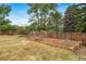 Backyard featuring multiple gardening beds in the lawn with a wooden fence in the background at 8051 S Kendall Blvd, Littleton, CO 80128