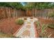 Tranquil backyard garden path lined with white gravel, stepping stones, and mulch at 8051 S Kendall Blvd, Littleton, CO 80128