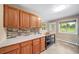 This kitchen has oak cabinets, a butcher block island, tile floors, and lots of natural light at 8051 S Kendall Blvd, Littleton, CO 80128