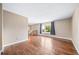 Large living space with hardwood flooring, staircase, and large window at 8051 S Kendall Blvd, Littleton, CO 80128