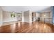 Open concept living space with hardwood flooring and multiple points of entry into other rooms at 8051 S Kendall Blvd, Littleton, CO 80128