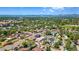 Scenic neighborhood aerial view of a community with lush trees, homes, and distant mountains at 550 S Raleigh St, Denver, CO 80219