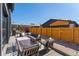 This backyard boasts stylish furniture, a privacy fence, and an outdoor lounge area at 550 S Raleigh St, Denver, CO 80219