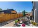 This backyard boasts stylish furniture, an outdoor dining area and a privacy fence at 550 S Raleigh St, Denver, CO 80219