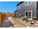This backyard boasts stylish furniture, a privacy fence, and an outdoor dining area at 550 S Raleigh St, Denver, CO 80219