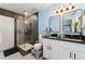 Stylish bathroom with double sinks, a glass-enclosed shower, and modern fixtures at 550 S Raleigh St, Denver, CO 80219
