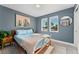 Cozy bedroom with ample natural light, wood floors, and neutral décor at 550 S Raleigh St, Denver, CO 80219