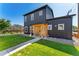 Modern home with black siding and a well-manicured lawn, complemented by a welcoming front porch at 550 S Raleigh St, Denver, CO 80219