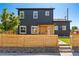 Contemporary two-story home featuring a wood-accented entrance, fenced yard, and modern design at 550 S Raleigh St, Denver, CO 80219