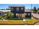 Two-story modern home with black siding, a well-maintained lawn, and a wooden fence at 550 S Raleigh St, Denver, CO 80219