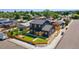 Modern two-story home features black siding, a well-kept lawn, and a charming wood fence at 550 S Raleigh St, Denver, CO 80219