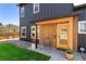 Close-up of the front porch of a home with a bright yellow door and modern design elements at 550 S Raleigh St, Denver, CO 80219