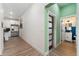 Hallway leading to the kitchen and featuring a bathroom to the right at 550 S Raleigh St, Denver, CO 80219