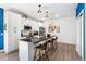 Bright kitchen with white cabinets, black countertops, stainless steel appliances and wood flooring at 550 S Raleigh St, Denver, CO 80219