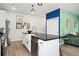 Kitchen with white cabinets, black countertops, stainless steel appliances, farmhouse sink and wood flooring at 550 S Raleigh St, Denver, CO 80219