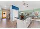 Kitchen with white cabinets, black countertops, stainless steel appliances, farmhouse sink and wood flooring at 550 S Raleigh St, Denver, CO 80219