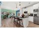 Bright kitchen with white cabinets, black countertops, stainless steel appliances and wood flooring at 550 S Raleigh St, Denver, CO 80219