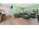 Spacious living room with hardwood floors and comfortable, stylish green seating at 550 S Raleigh St, Denver, CO 80219
