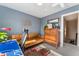 This office boasts a leather couch, a vintage dresser, and a view to the hall at 550 S Raleigh St, Denver, CO 80219