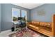 This office features two windows, a comfortable leather couch and modern art at 550 S Raleigh St, Denver, CO 80219