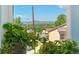 Mountain and neighborhood view through a window with greenery in the foreground at 550 S Raleigh St, Denver, CO 80219