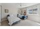 Bright bedroom with two twin beds, carpet, and a window with patterned curtains at 938 W Peakview Cir, Littleton, CO 80120