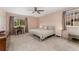 Light and airy main bedroom with pink walls, two windows, and neutral carpeting at 938 W Peakview Cir, Littleton, CO 80120