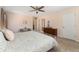 Spacious bedroom with light pink walls, a floral comforter and coordinating night stands at 938 W Peakview Cir, Littleton, CO 80120