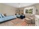 Comfortable bedroom with two twin beds, a reading chair, and a large window at 938 W Peakview Cir, Littleton, CO 80120