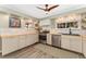 Well-lit kitchen with stainless steel appliances, butcher block countertops, and ample cabinet space at 938 W Peakview Cir, Littleton, CO 80120