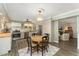 Charming eat-in kitchen with a round table, stainless steel appliances, and hardwood floors at 938 W Peakview Cir, Littleton, CO 80120
