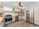 Modern kitchen with stainless steel appliances, butcher block countertops, and stylish backsplash at 938 W Peakview Cir, Littleton, CO 80120