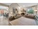 Inviting living room with a fireplace, neutral decor, and a view to the adjacent dining area at 938 W Peakview Cir, Littleton, CO 80120