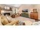 Cozy living room features a stone fireplace, neutral tones, plush seating, and large TV at 938 W Peakview Cir, Littleton, CO 80120